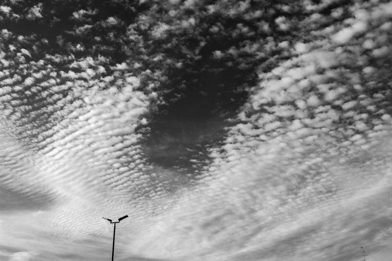 a black and white photo of some clouds in the sky