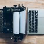 gray typewriter and MacBook